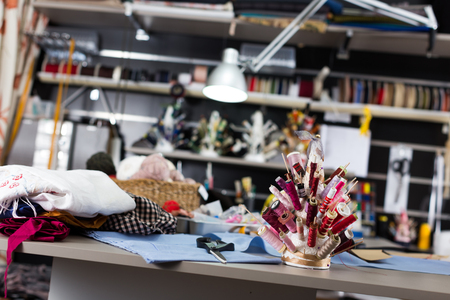 Image of workplace  in sewing shop of variety clothes factoryの写真素材
