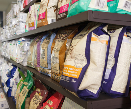 BARCELONA, SPAIN - MAY 07, 2018: Variety of pet food and accessories in supermarketのeditorial素材