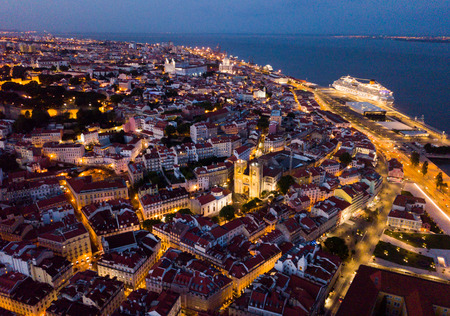 Night aerial view of downtown of Lisbon overlooking medieval Cathedral and Castle of Sao Jorge, Portugalの写真素材