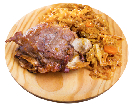 Traditional spanish dish galtas al horno, baked pork cheeks with braised cabbage. Isolated over white backgroundの写真素材