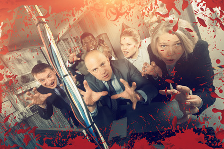 Group of adult men and women trying to get out of escape room stylized like thrillerの写真素材