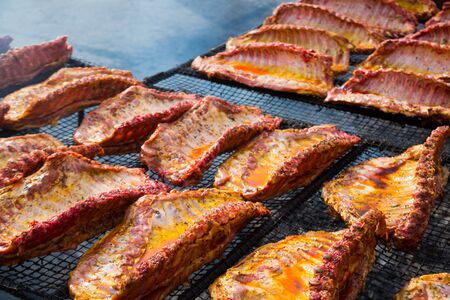 Image of tasty pork ribs preparing on grill brazier outdoorsの写真素材