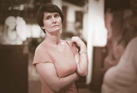 Portrait of woman who is looking at the exposition in historical museum