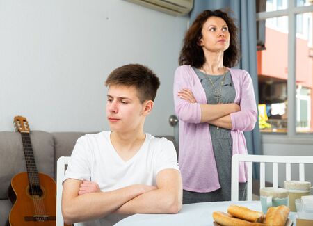 Portrait of family of mother and teenage son offended after quarrelの写真素材
