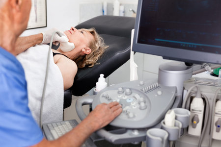 Cheerful positive  mature woman getting ultrasound scanning examination at clinic