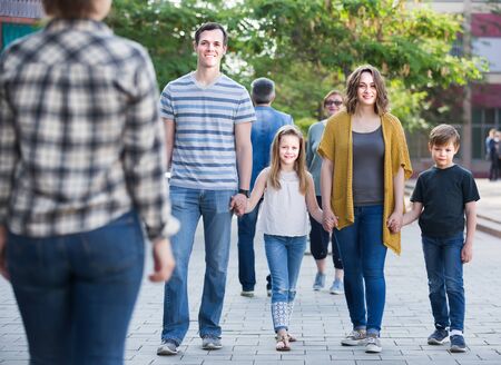 Friendly and positive family with children walking in the park on vacation togetherの写真素材