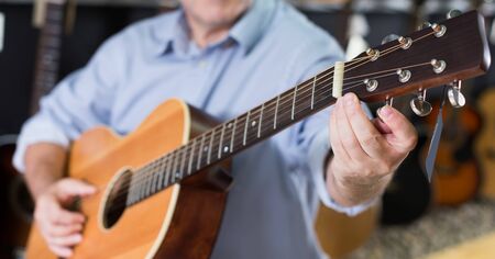 Picture of modern wooden acoustic guitar in music shop.の写真素材
