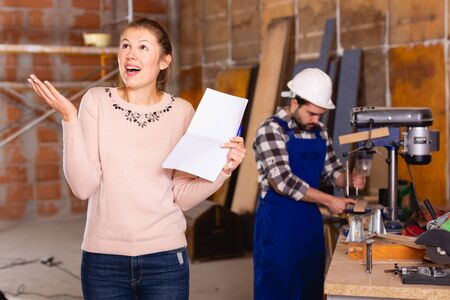 Architect with drawing checks the work of buildersの写真素材