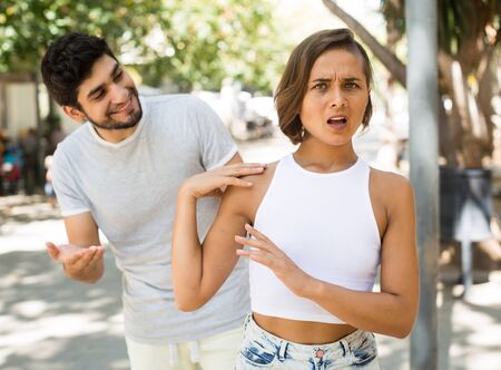 portrait of adult male and female talking emotional at the streetの写真素材