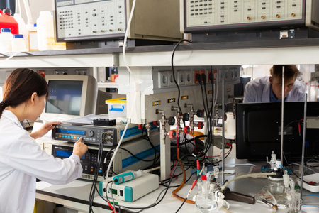 international group of young scientists using lab equipment during researchの写真素材
