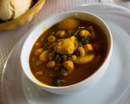 Stew from chopped stems and leaves of chard with garbanzo served in white bowlの写真素材