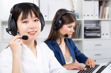 Operators working with computers in an officeの写真素材