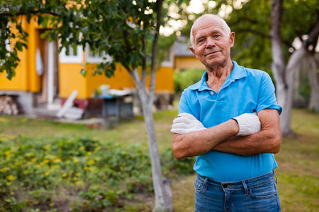 Portrait of positive mature farmer in his garden