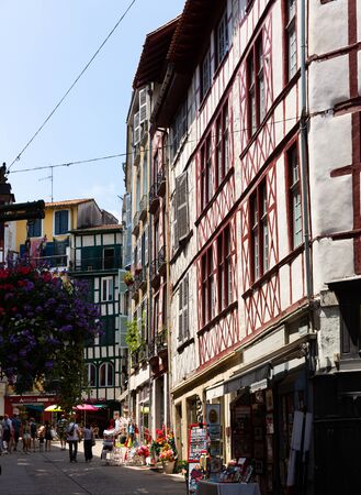 BAYONNE, FRANCE - JULY 17, 2019: Traditional Basque architecture of Bayonne streets. View of half-timbered houses on narrow street in French townのeditorial素材