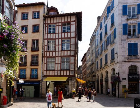 BAYONNE, FRANCE - JULY 17, 2019: Traditional Basque architecture of Bayonne streets. View of half-timbered houses on narrow street in French townのeditorial素材