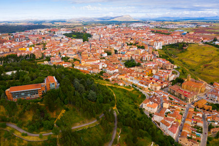 Scenic view from drone of Soria cityscape on bank of Douro river in summer day, Spain