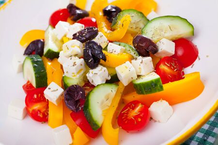 Appetizing Greek salad with feta cheese, fresh vegetables and black olivesの写真素材