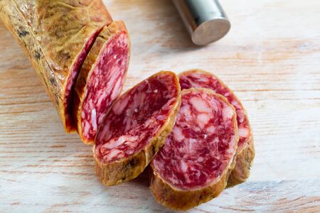 Close-up of spanish salchichon sausage at wooden surface, nobodyの写真素材