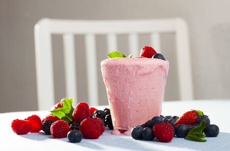 Delicious yogurt smoothie with diversity fresh berries and mint for healthy breakfastの写真素材