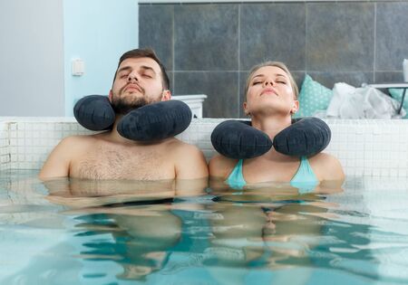 Young happy family having wellness weekend in hot tubin spa centerの写真素材