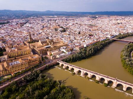 Aerial view of cityscape of Cordoba with  Roman Bridge over the Guadalquivir and the Mosque-Cathedral of Cordobaの写真素材