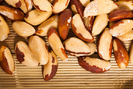 Brazil nuts on wooden surface, closeup