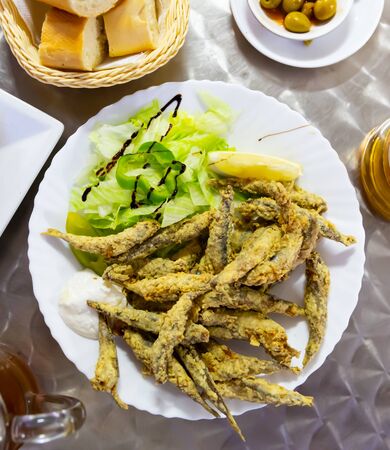 Closeup of fried anchovies food with sauceの写真素材