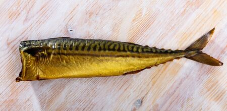 Traditional Russian appetizer. Tasty cold smoked mackerel on wooden tableの写真素材