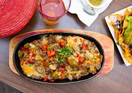 Pan of veal meat roasted with bell pepper and eggs (Alambre de ternera) - dish of Mexican cuisineの写真素材