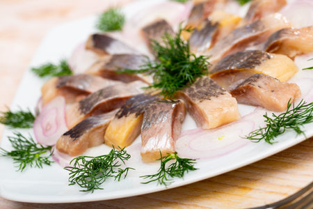 Mediterranean herring fillet served with sliced onion rings and dill