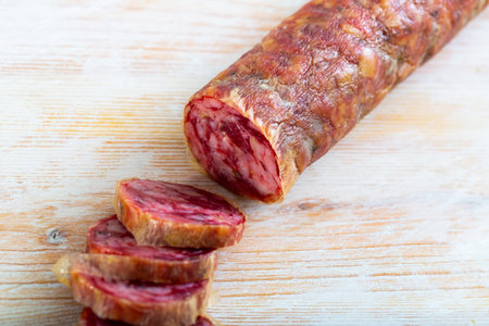 Close-up of spanish salchichon sausage at wooden surface, nobody