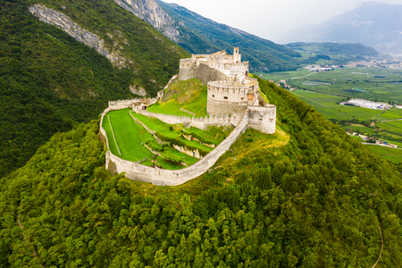Scenic aerial view of large fortified Beseno castle on top of hill in Besenello, Italyのeditorial素材