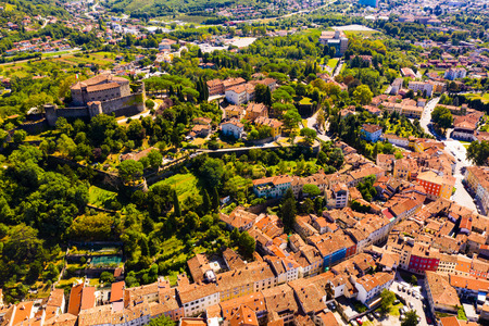 Aerial view of Gorizia cityscape overlooking ancient fortress on top on hill in sunny autumn day, Italyのeditorial素材