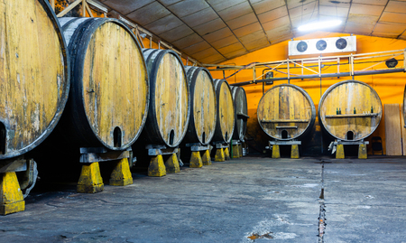 Inside view of Asturian Sidreria with wooden cider barrelsのeditorial素材