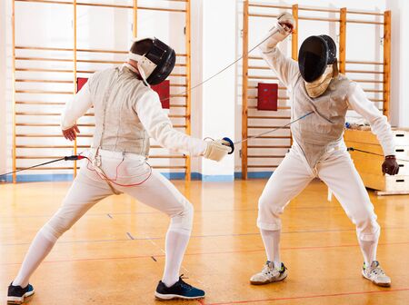 active fencers at fencing workout, practicing attack movements in battleの素材 [FY310132121241]