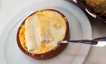 Delicious Italian pasta Cannelloni or Manicotti baked with cheese in bowl