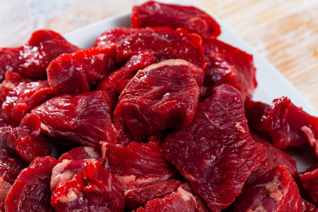 Fresh uncooked chopped beef on wooden table