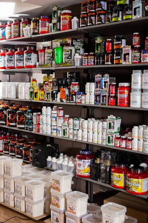 BARCELONA, SPAIN - SEPTEMBER 20, 2019: Shelves with dietary supplements, vitamins and minerals in sports nutrition shopのeditorial素材