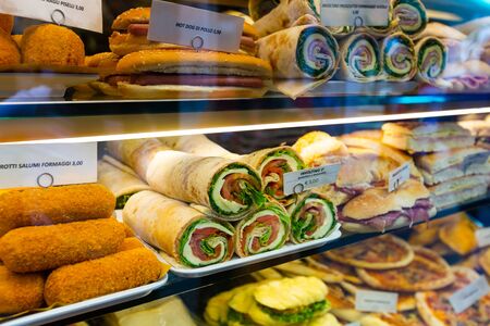 Variety of fresh cooked fast food dishes suited to every fancy on display of cafe in Veniceの写真素材