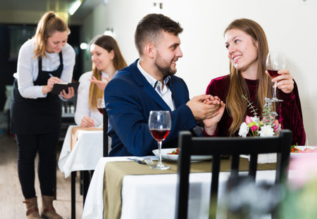 Romantic couple is having dinner in the restaurante indoor.の写真素材