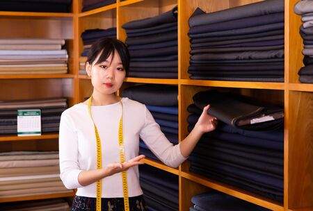 Professional seller of fabrics in clothing storeの写真素材
