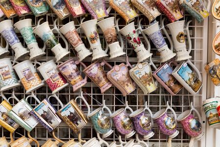 KARLOVY VARY, CZECH REPUBLIC - OCTOBER 10, 2019: Famous souvenirs of Karlovy Vary mugs and cups for mineral water displayed in shop for saleのeditorial素材