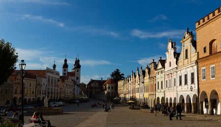 TELC, CZECH REPUBLIC - OCTOBER 12, 2019: View of historic center of Telc town - ancient houses and fountain with statue of Virgin on main square on background with church belfriesのeditorial素材