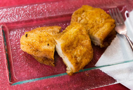 Crispy outside and smooth inside sweet Madrid torrijas served on glass plate. Spanish cuisine