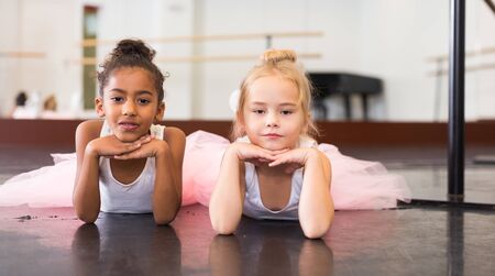 Portrait of two little ballerinas practicing choreography in dance hallの写真素材