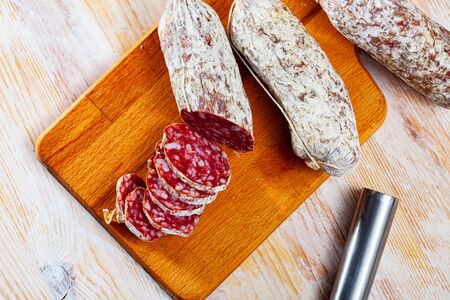 Italian cacciatori salami sausages on a wooden tableの写真素材