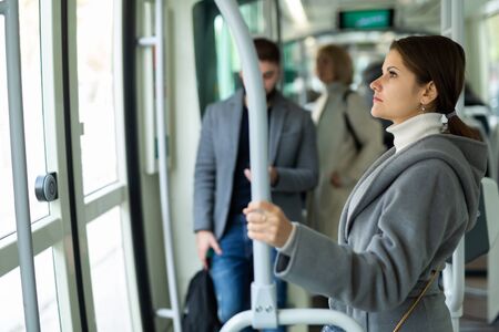 Portrait of positive female passenger traveling in tramの写真素材