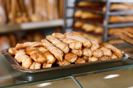Closeup of tray with delicious sweet pastry presented on bakery showcaseの写真素材