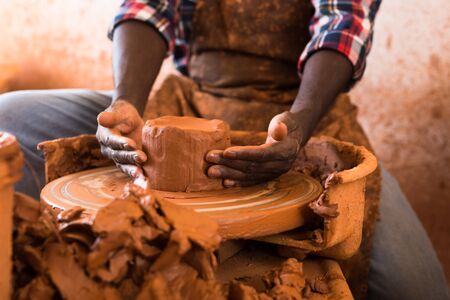 Close up of hands working on pottery wheel in workshopの写真素材