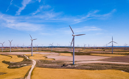 Wind Turbines at farmland in summer near the town of La Muela, Spain